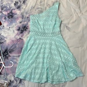 A teal one shoulder dress